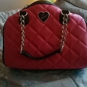Im selling a pink and black Betsey Johnson bag.